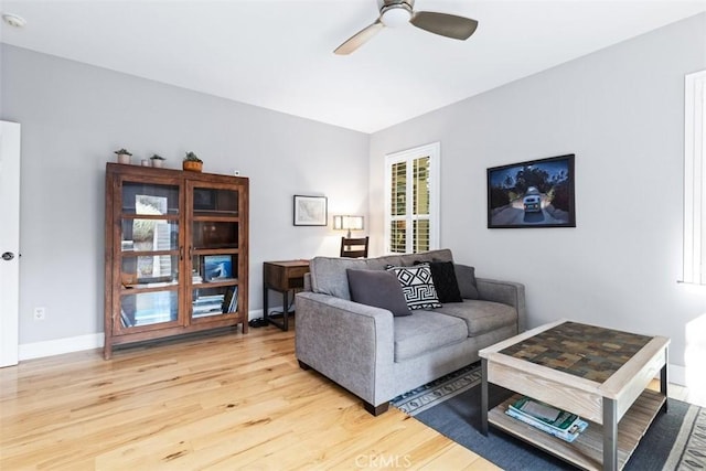 living room featuring light hardwood / wood-style floors and ceiling fan