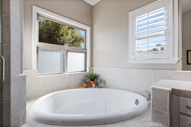 bathroom with a tub to relax in