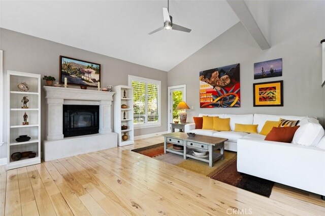 living room featuring high vaulted ceiling, hardwood / wood-style floors, and ceiling fan