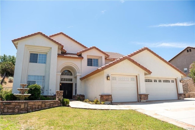 mediterranean / spanish-style home featuring a front yard and a garage