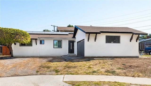 view of front of house with solar panels