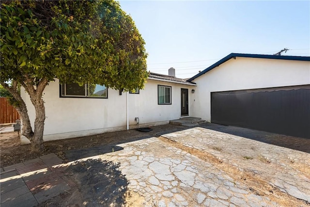 rear view of house featuring a garage