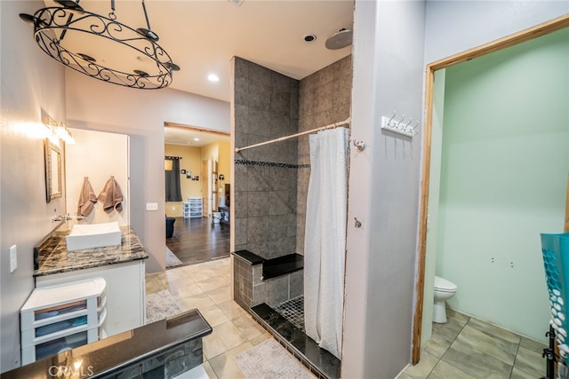 bathroom featuring a shower with curtain, vanity, toilet, and hardwood / wood-style flooring