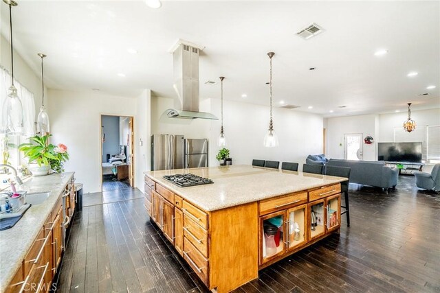 kitchen with island exhaust hood, plenty of natural light, and dark hardwood / wood-style flooring