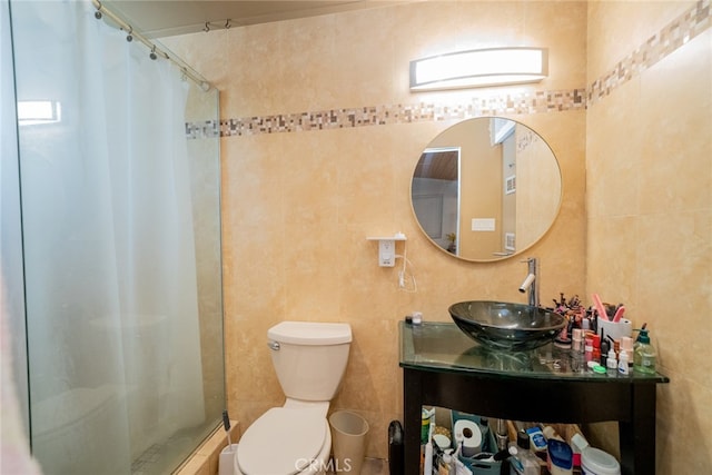 bathroom featuring tile walls, vanity, toilet, and a shower with shower curtain