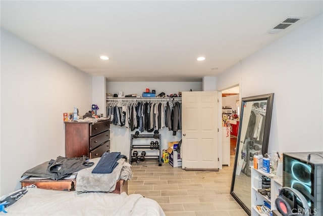 bedroom with light hardwood / wood-style flooring and a closet