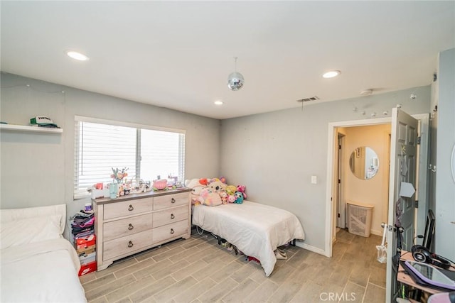 bedroom featuring wood finish floors, visible vents, baseboards, and recessed lighting