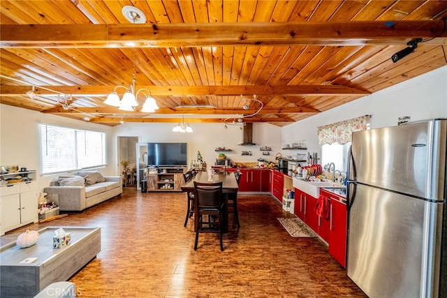 kitchen with hanging light fixtures, stainless steel fridge, beam ceiling, wooden ceiling, and a notable chandelier