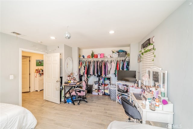 bedroom with light hardwood / wood-style flooring and a closet