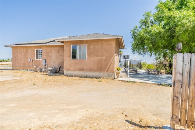 back of property with a patio and central AC unit