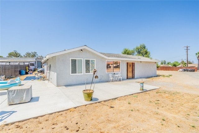 back of property featuring a patio