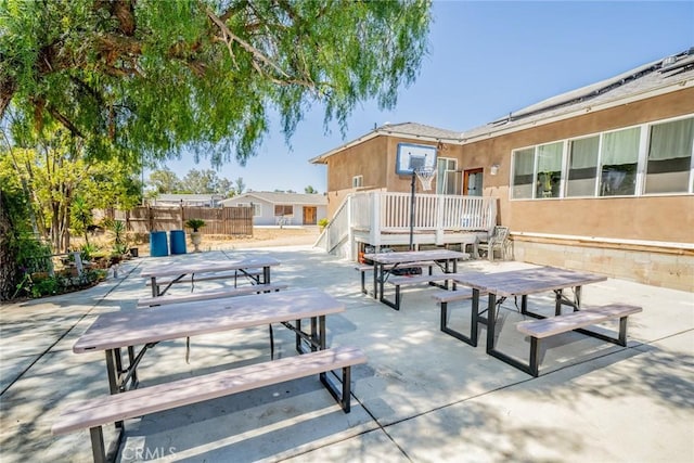 view of property's community with a patio area, fence, and outdoor dining area