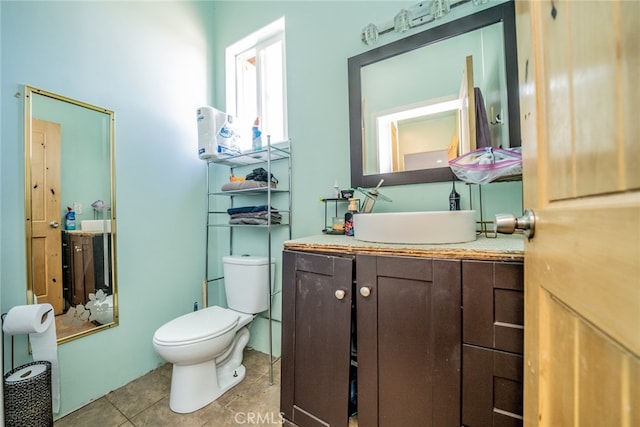 bathroom featuring tile patterned flooring, vanity, and toilet