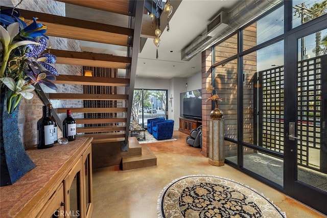 interior space with a towering ceiling and concrete floors