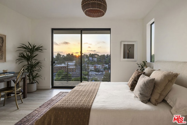 bedroom with access to exterior and light wood-type flooring