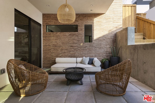 view of patio featuring an outdoor living space with a fire pit