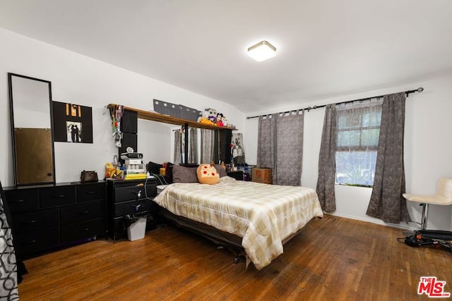 bedroom with hardwood / wood-style flooring