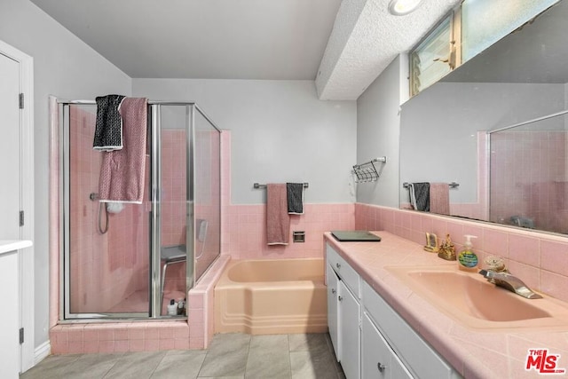 bathroom featuring tile patterned flooring, vanity, and plus walk in shower