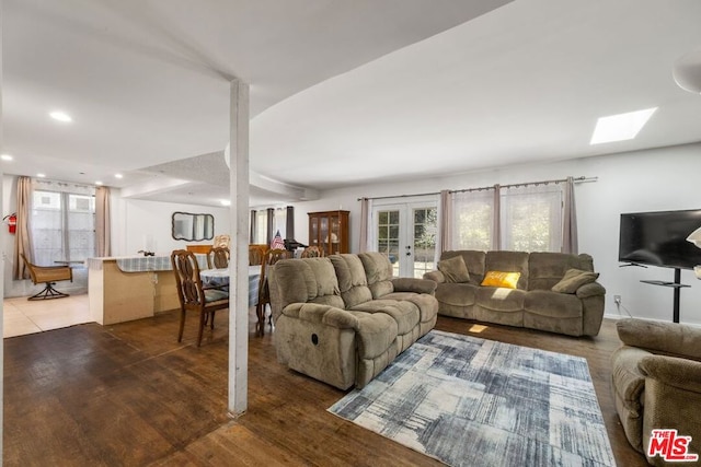 living room with french doors and dark wood-type flooring