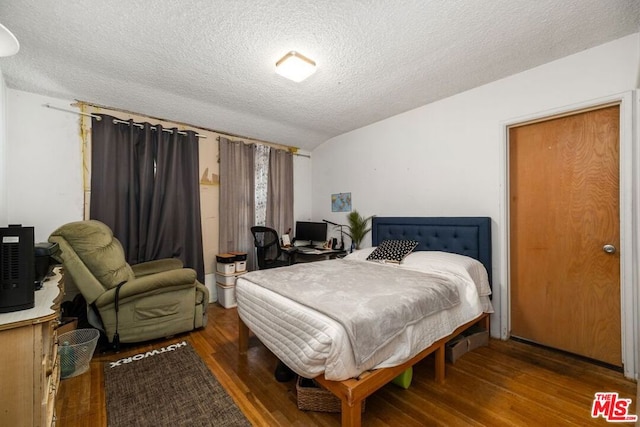 bedroom with wood-type flooring and a textured ceiling