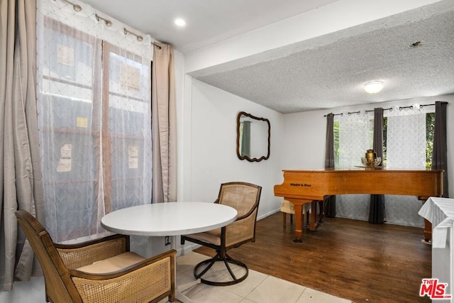 dining room featuring a textured ceiling and hardwood / wood-style flooring