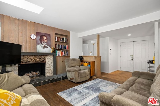 living room with a fireplace and dark hardwood / wood-style flooring