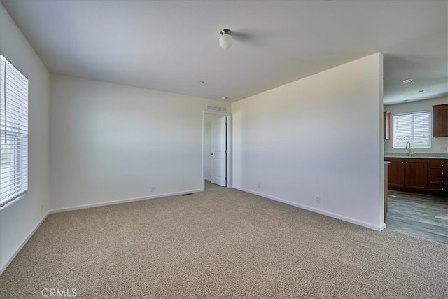 carpeted empty room with sink