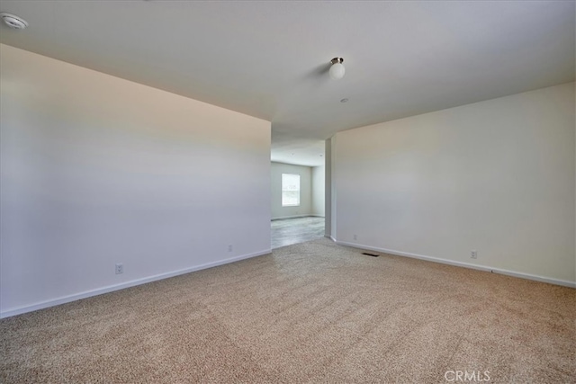 unfurnished room with light colored carpet