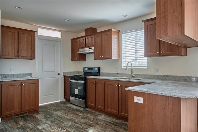 kitchen featuring stainless steel range, dark hardwood / wood-style floors, light stone countertops, and sink