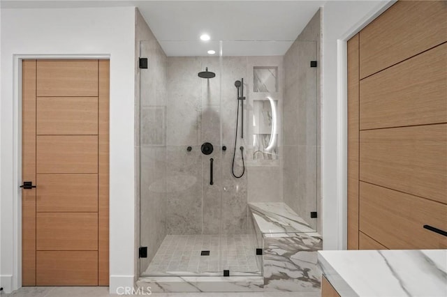 bathroom with a shower with door