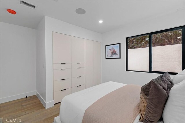 bedroom featuring a closet and light hardwood / wood-style floors