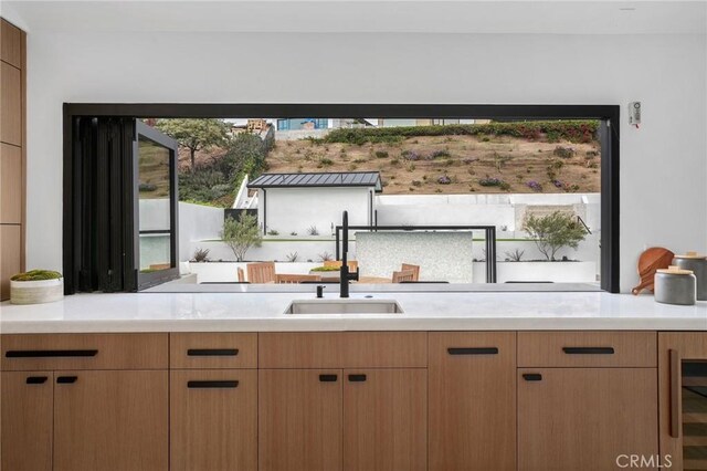 kitchen featuring wine cooler and sink