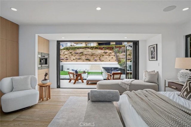 bedroom featuring light hardwood / wood-style flooring and access to outside