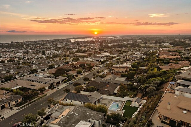 aerial view at dusk with a water view