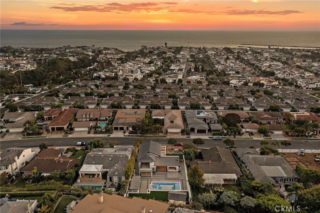 aerial view at dusk with a water view