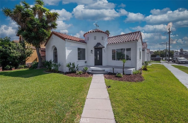 mediterranean / spanish-style home featuring a front lawn