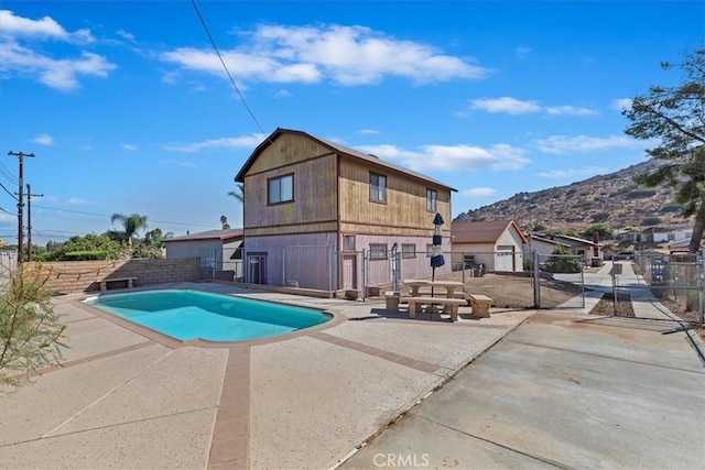 view of pool with a patio and a mountain view