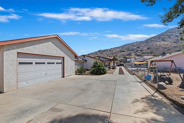 exterior space featuring a garage and a mountain view