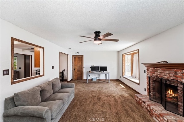 carpeted living room featuring ceiling fan, a textured ceiling, and a fireplace