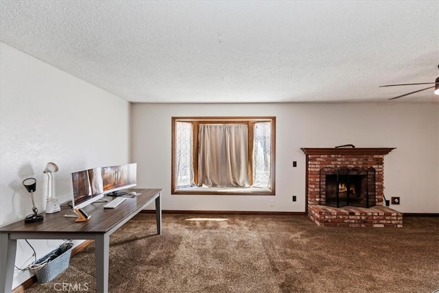 carpeted office space with a textured ceiling, ceiling fan, and a brick fireplace