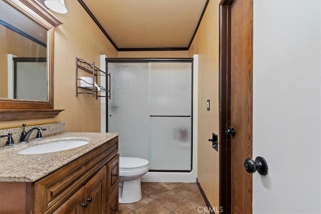 bathroom featuring a shower with door, toilet, tile patterned flooring, crown molding, and vanity