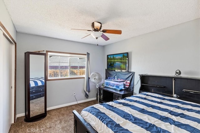 carpeted bedroom with a textured ceiling, a closet, and ceiling fan