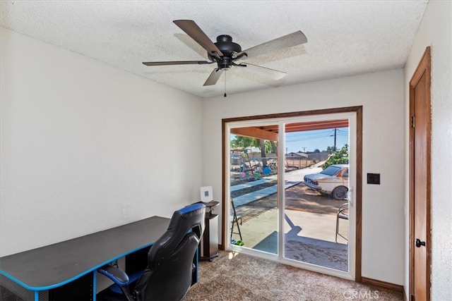 carpeted office space with ceiling fan and a textured ceiling