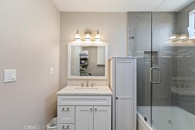 bathroom featuring vanity and enclosed tub / shower combo