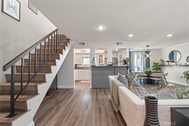 living room featuring dark hardwood / wood-style flooring and ornamental molding