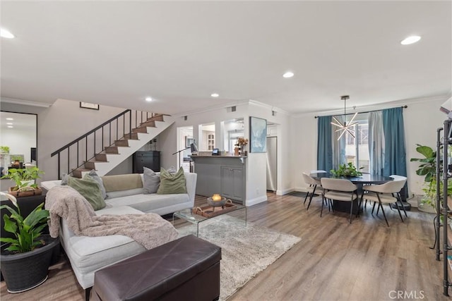 living room featuring light wood-type flooring and crown molding