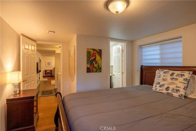 bedroom with wood-type flooring