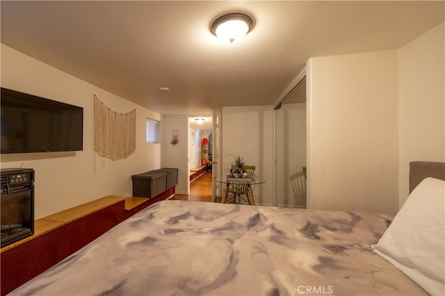 bedroom with a textured ceiling and a closet