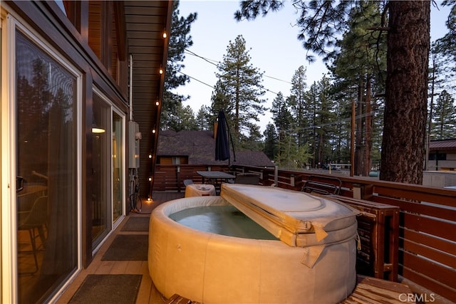 wooden deck featuring a hot tub