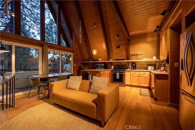 living room with beamed ceiling, light hardwood / wood-style flooring, wood walls, and high vaulted ceiling